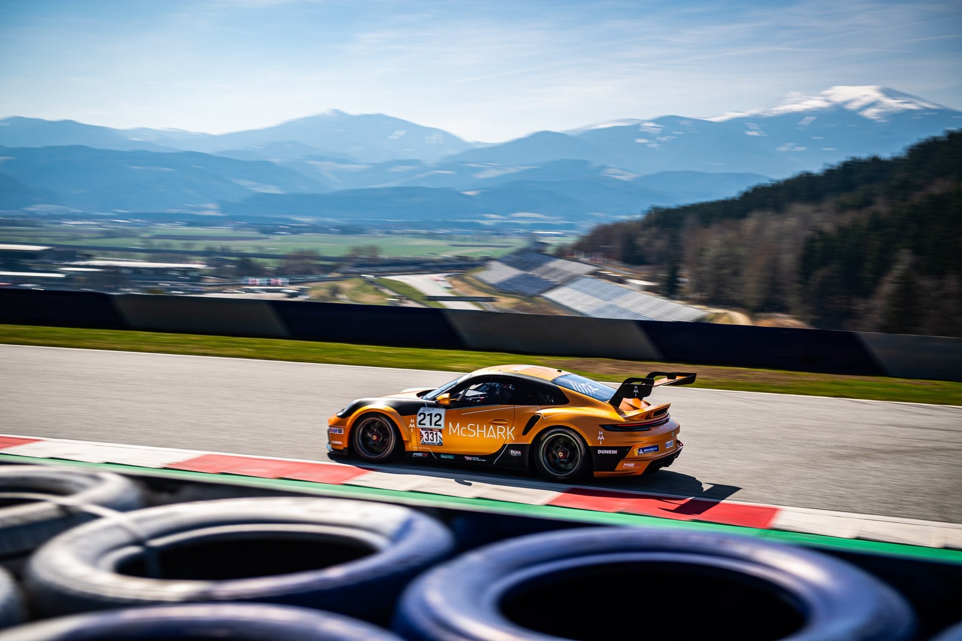 Orange Porsche on the racetrack